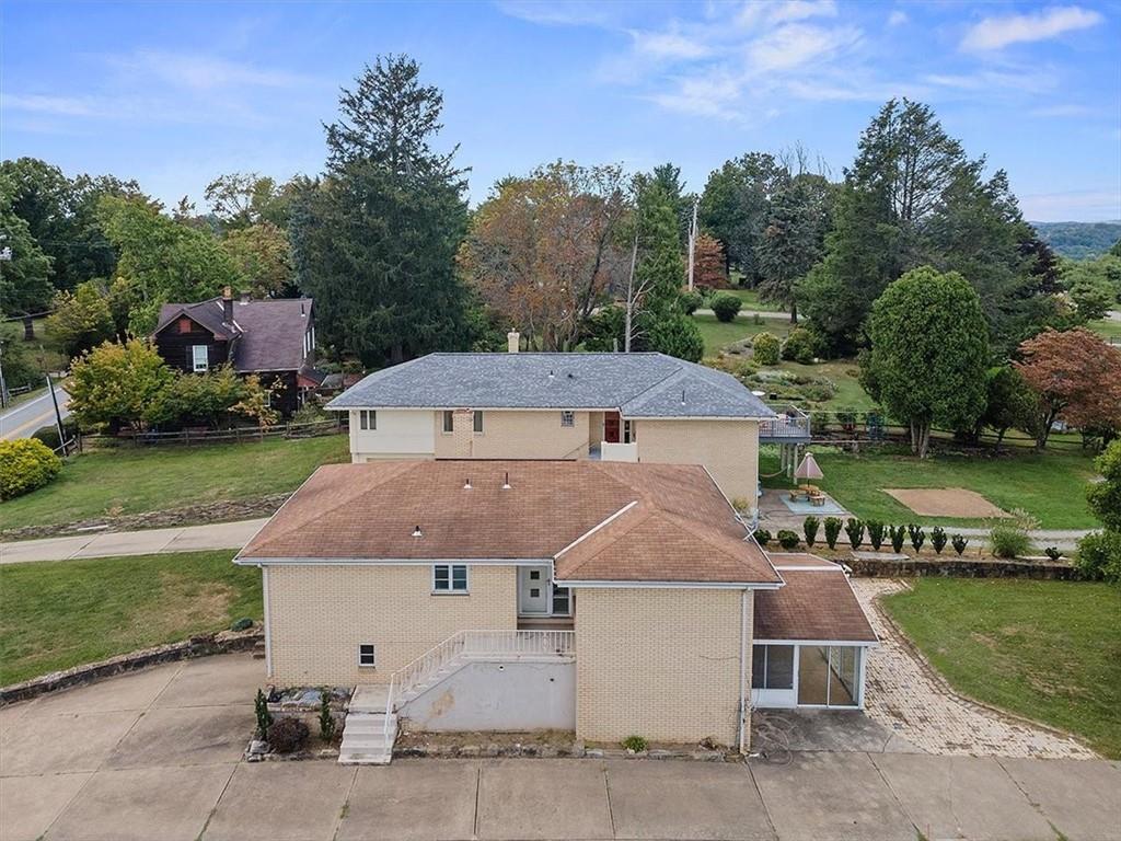 an aerial view of a house with a garden and a yard