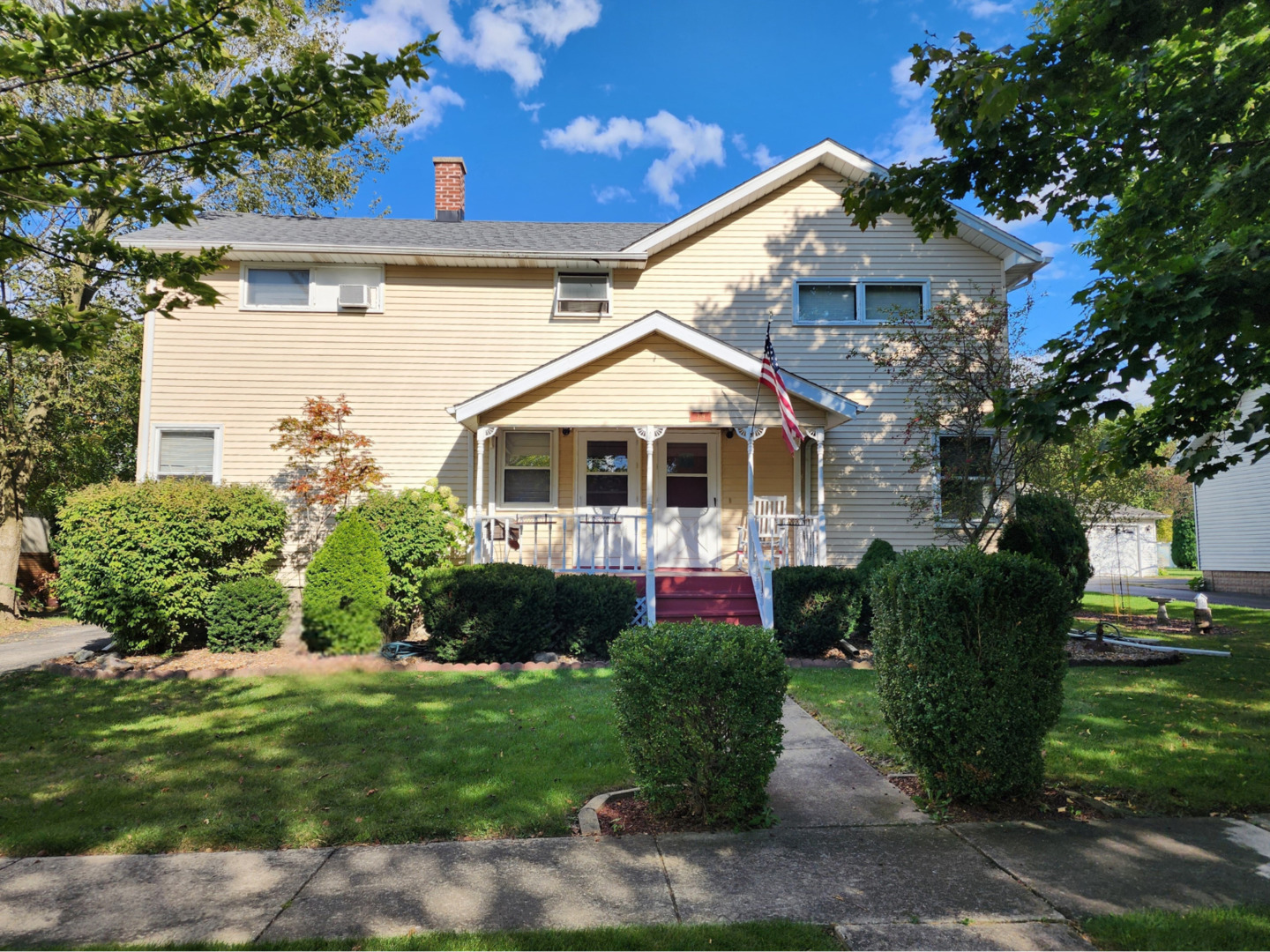 a front view of a house with a garden