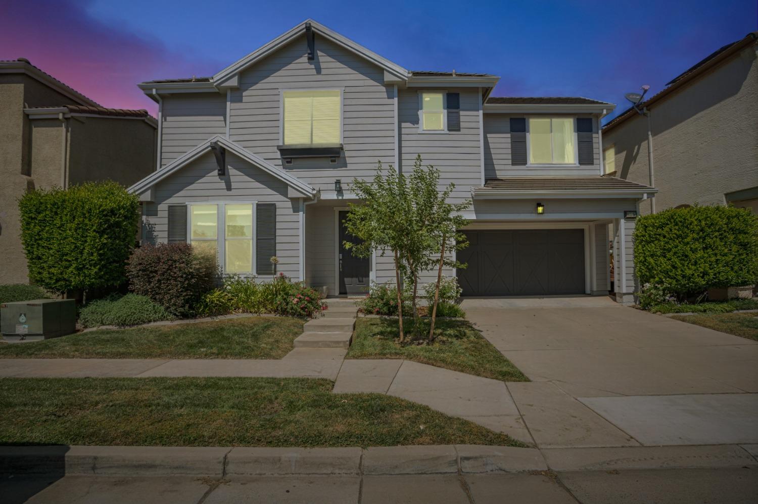 a front view of a house with a garden