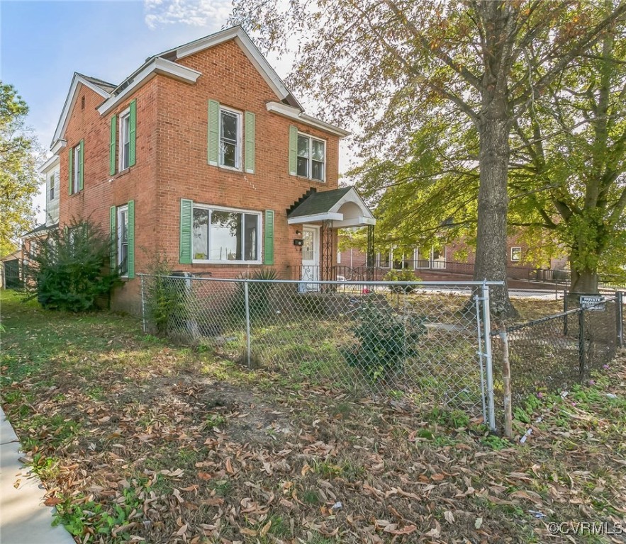 a front view of a house with plants