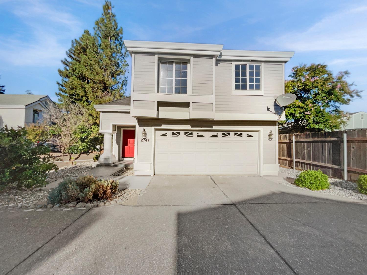 a view of a house with a backyard and a garage