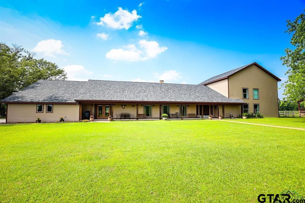 a view of a house with garden and backyard