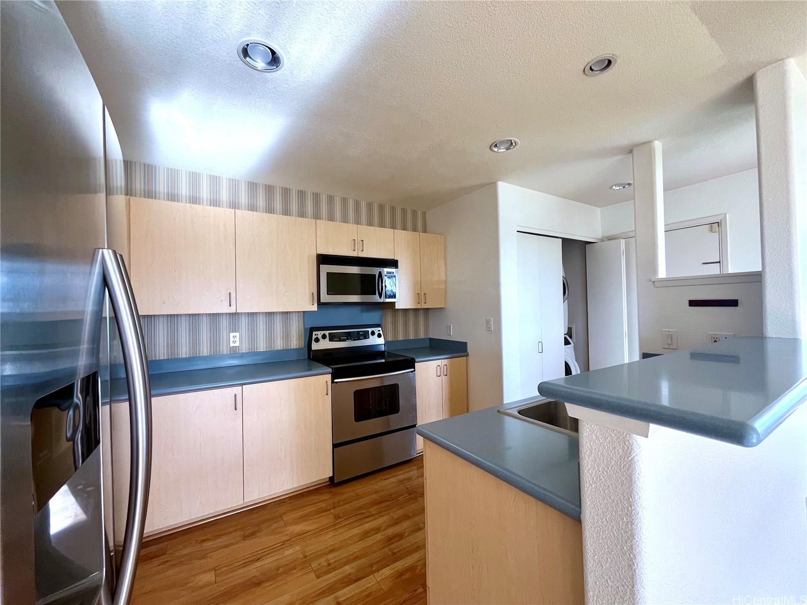 a kitchen with stainless steel appliances granite countertop a sink and stove top oven