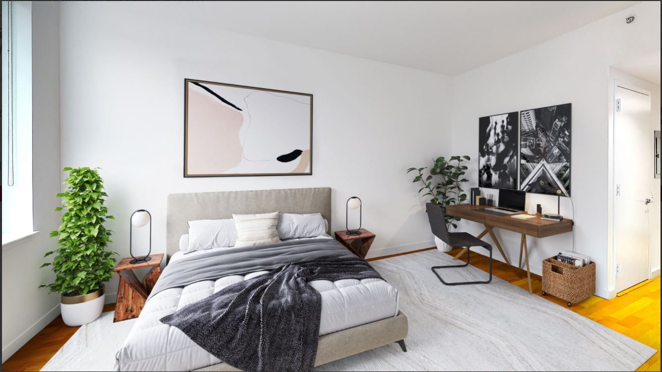 a bedroom with bed and a potted plant