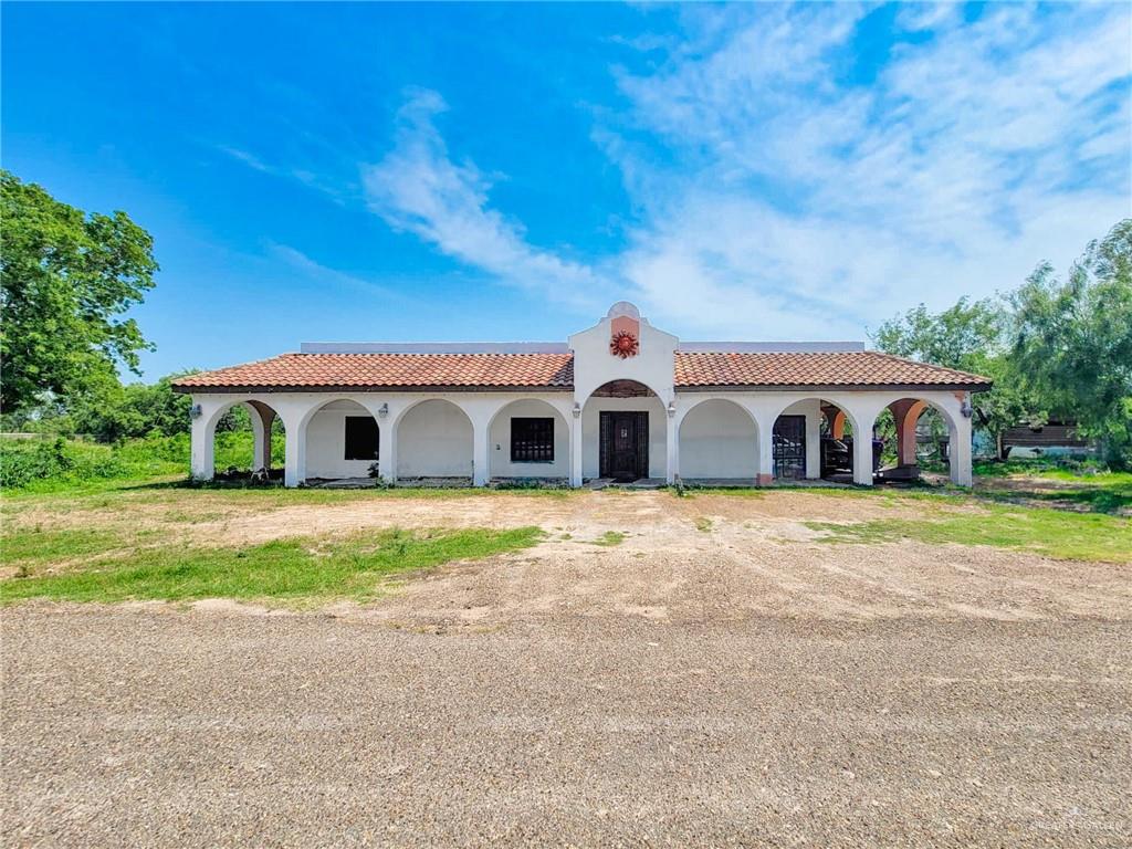 a front view of house with yard and garage