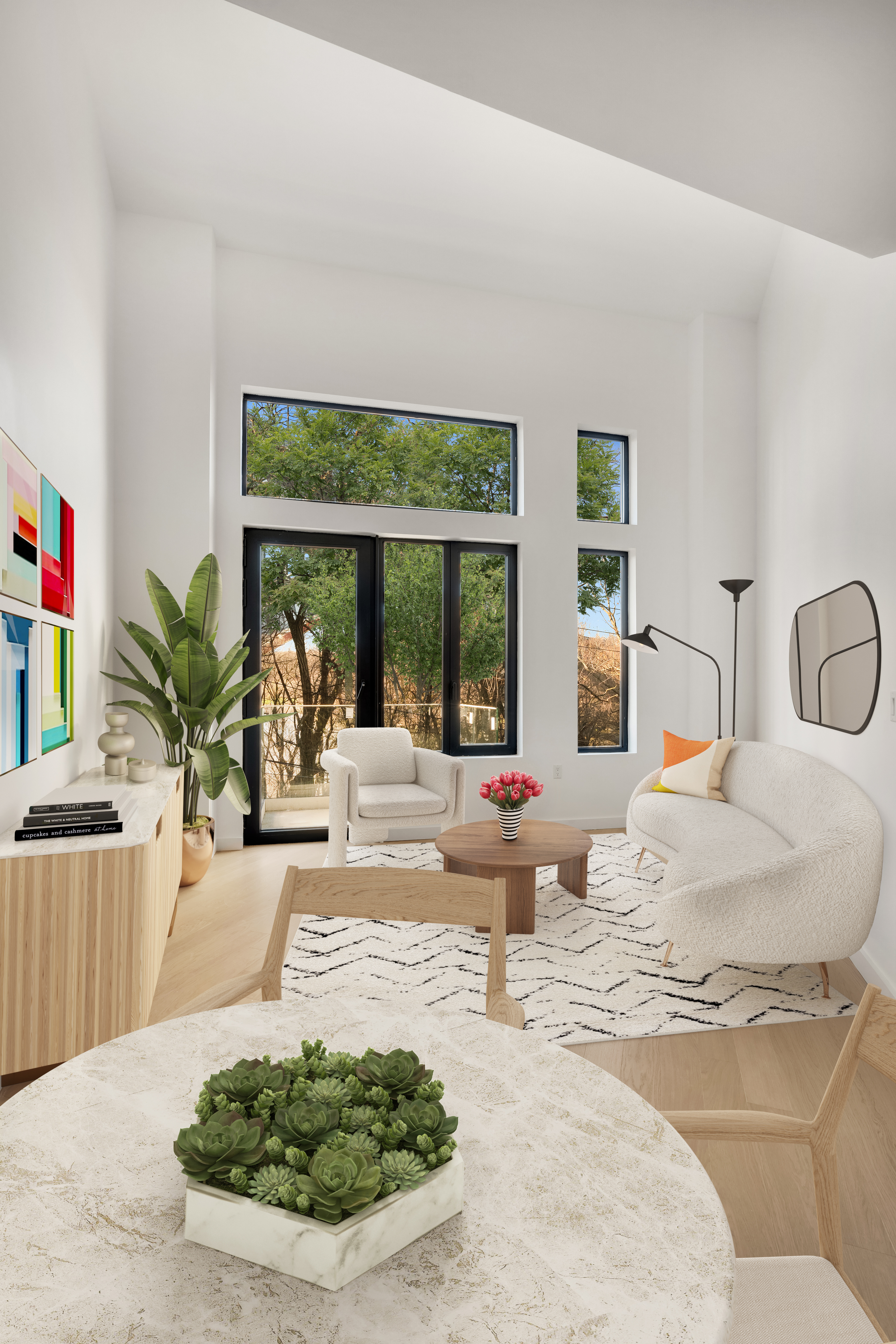 a living room with furniture potted plant and a large window