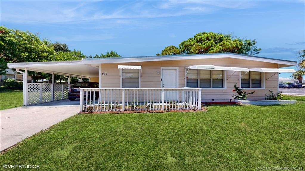 a view of a house with a backyard and a patio