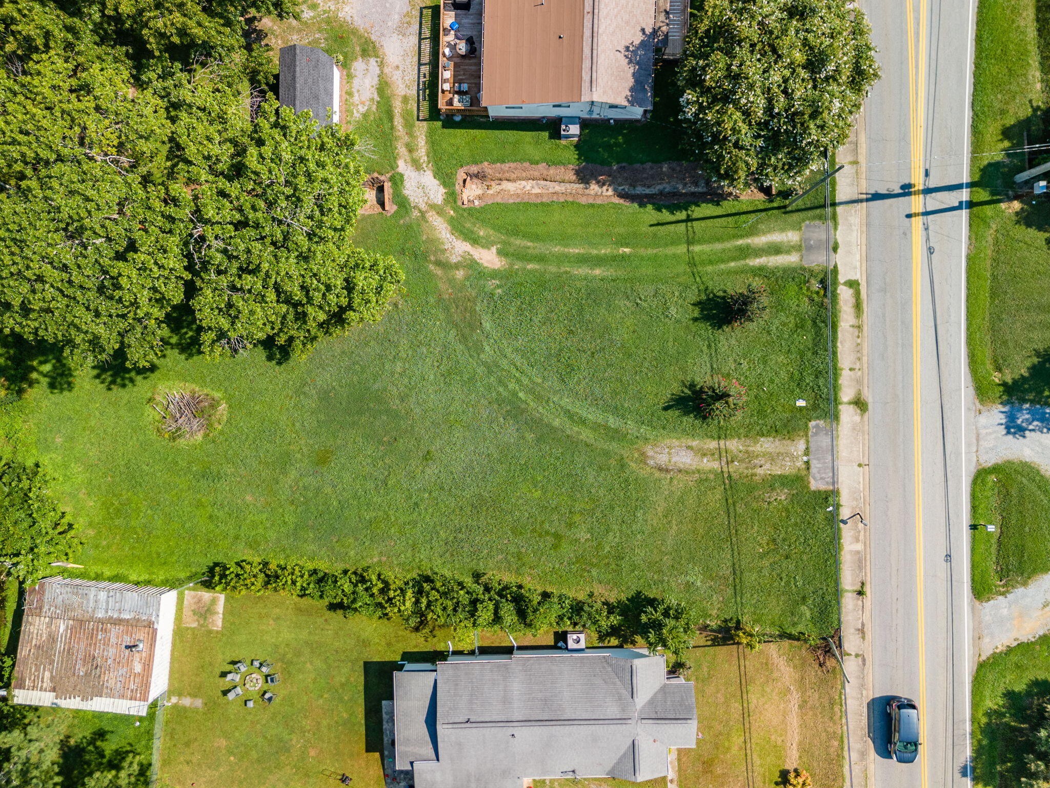 an aerial view of a residential houses with outdoor space and street view