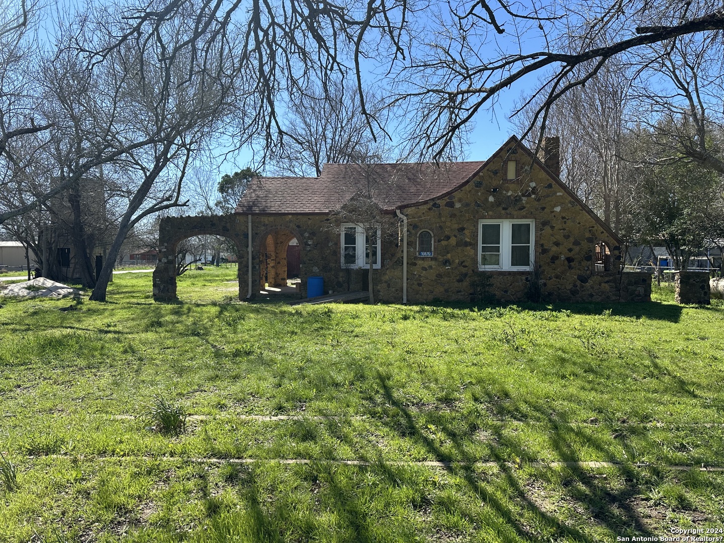 a view of house with yard and green space