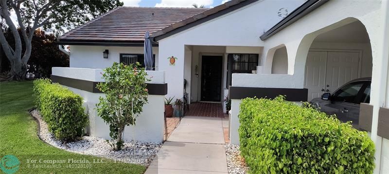 a front view of a house with garden