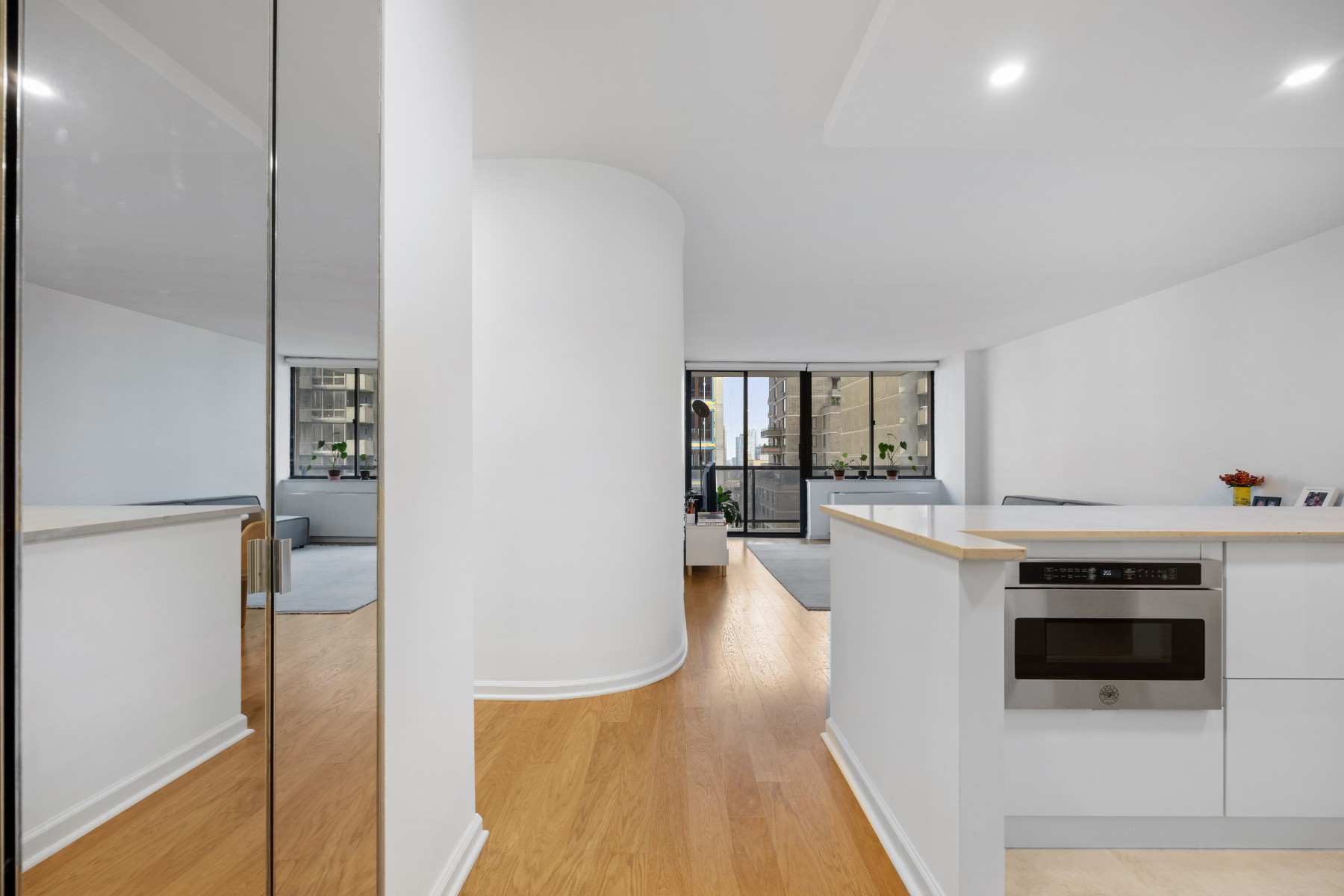 a kitchen with stainless steel appliances a stove cabinets and a wooden floor