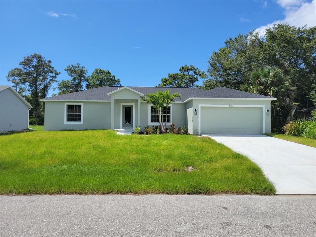 a front view of house with a garden