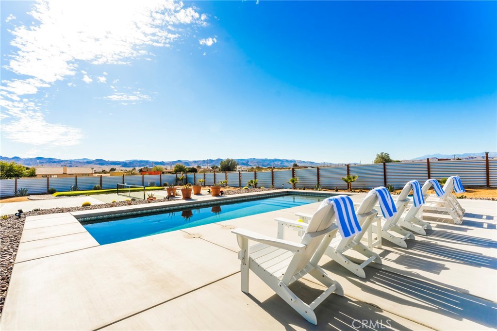 a view of swimming pool with furniture and outdoor seating