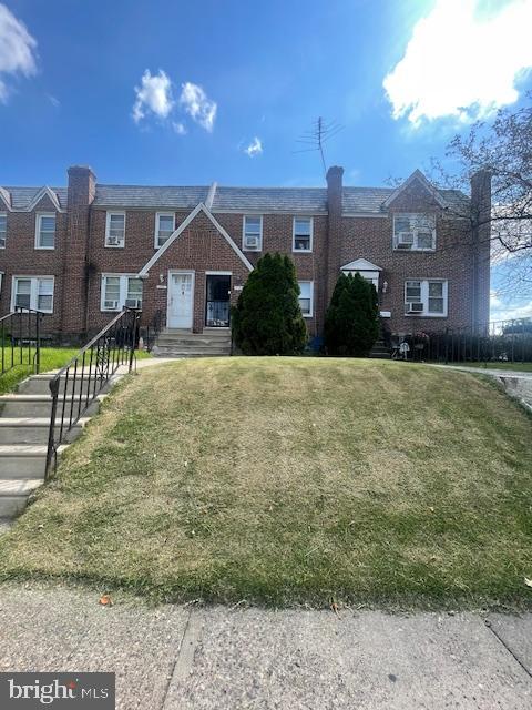 a front view of a house with a yard