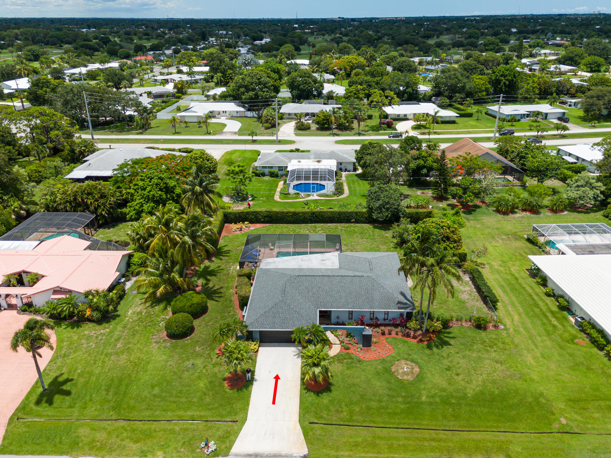 an aerial view of residential houses with outdoor space and lake view