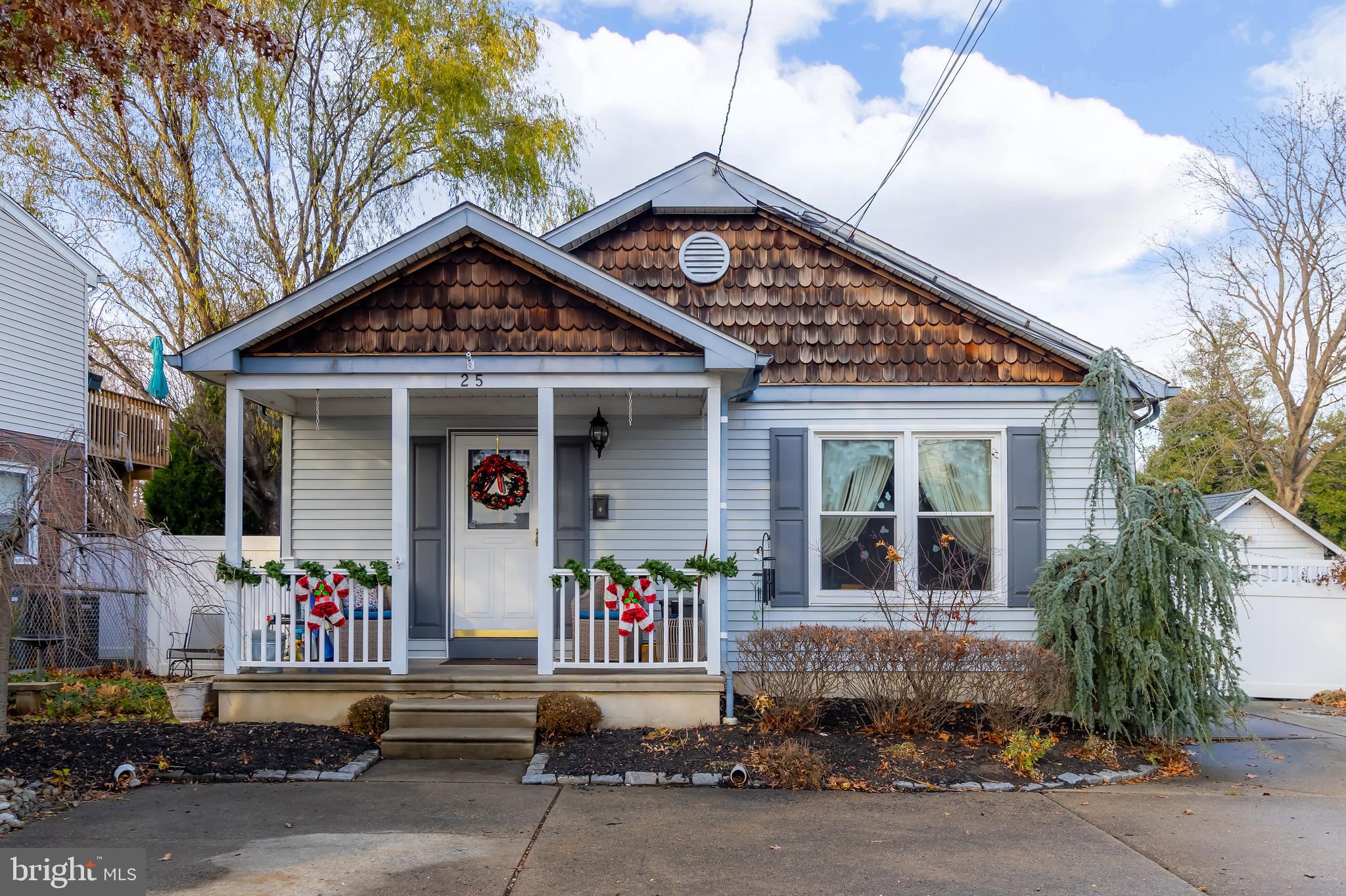 a front view of a house with a tree