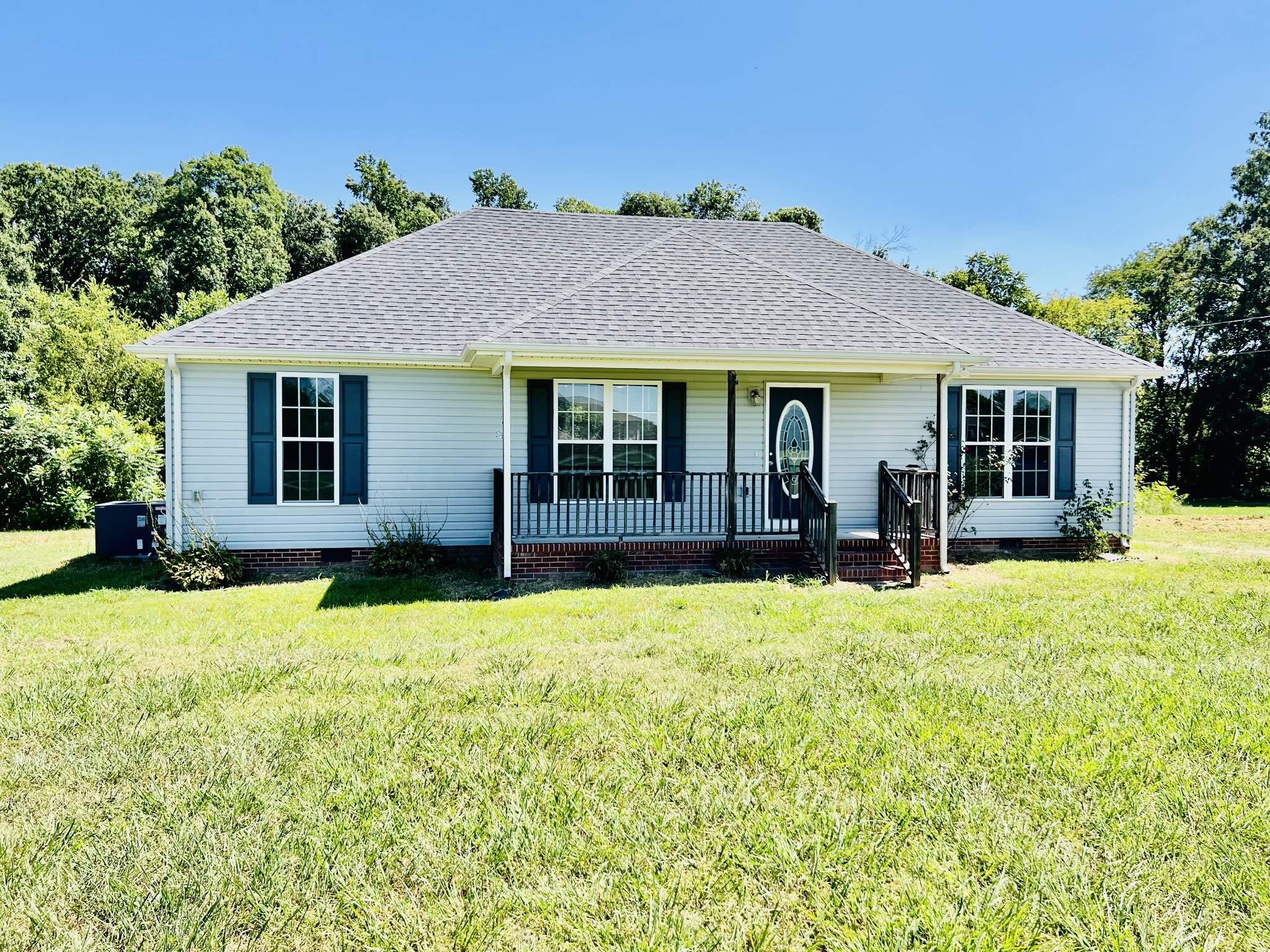 a view of a house with yard and sitting area