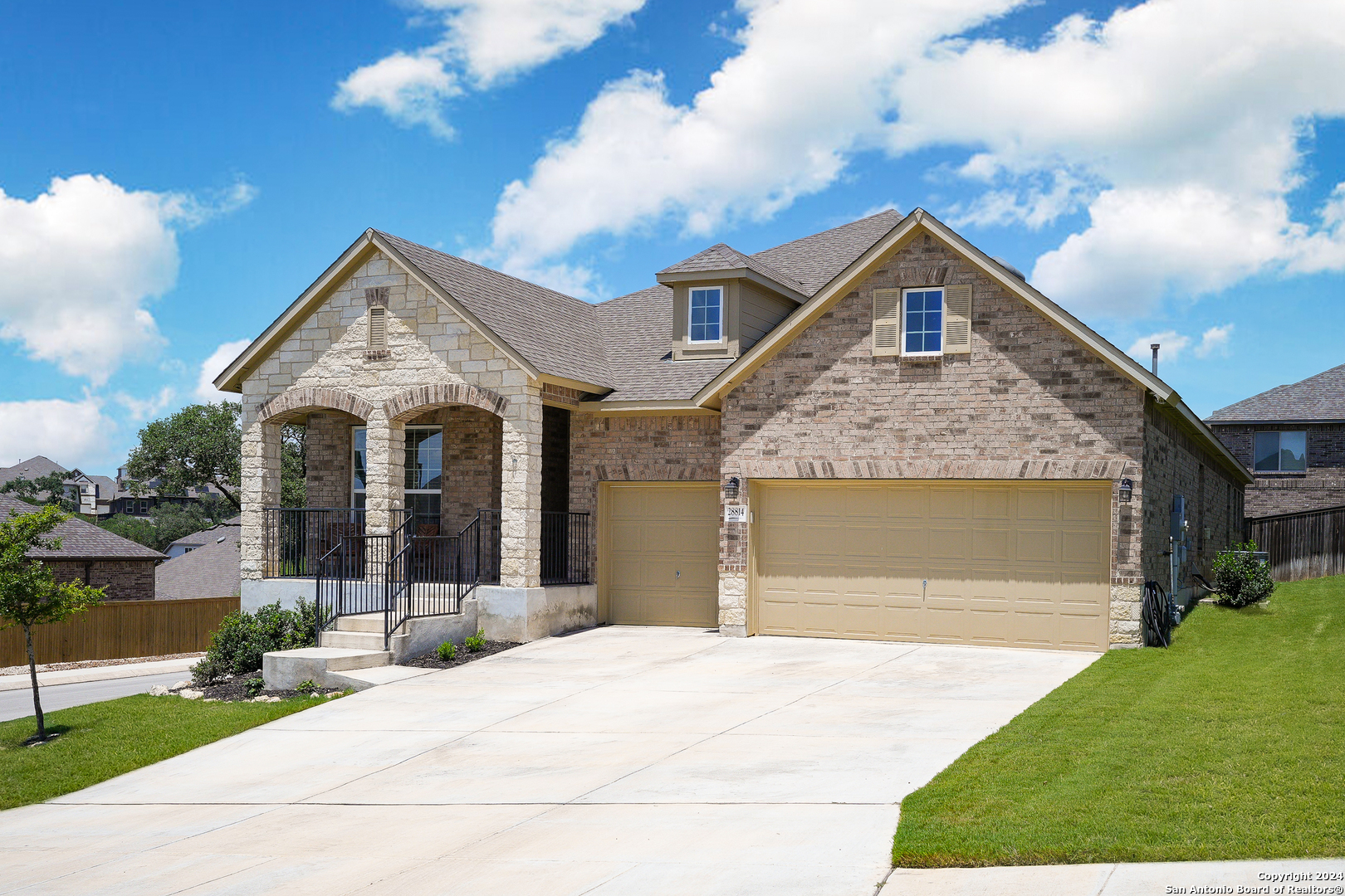 a front view of a house with garden