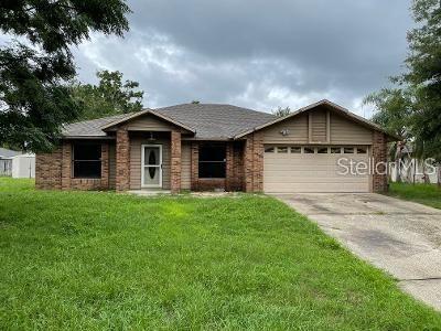 a front view of a house with a garden and yard