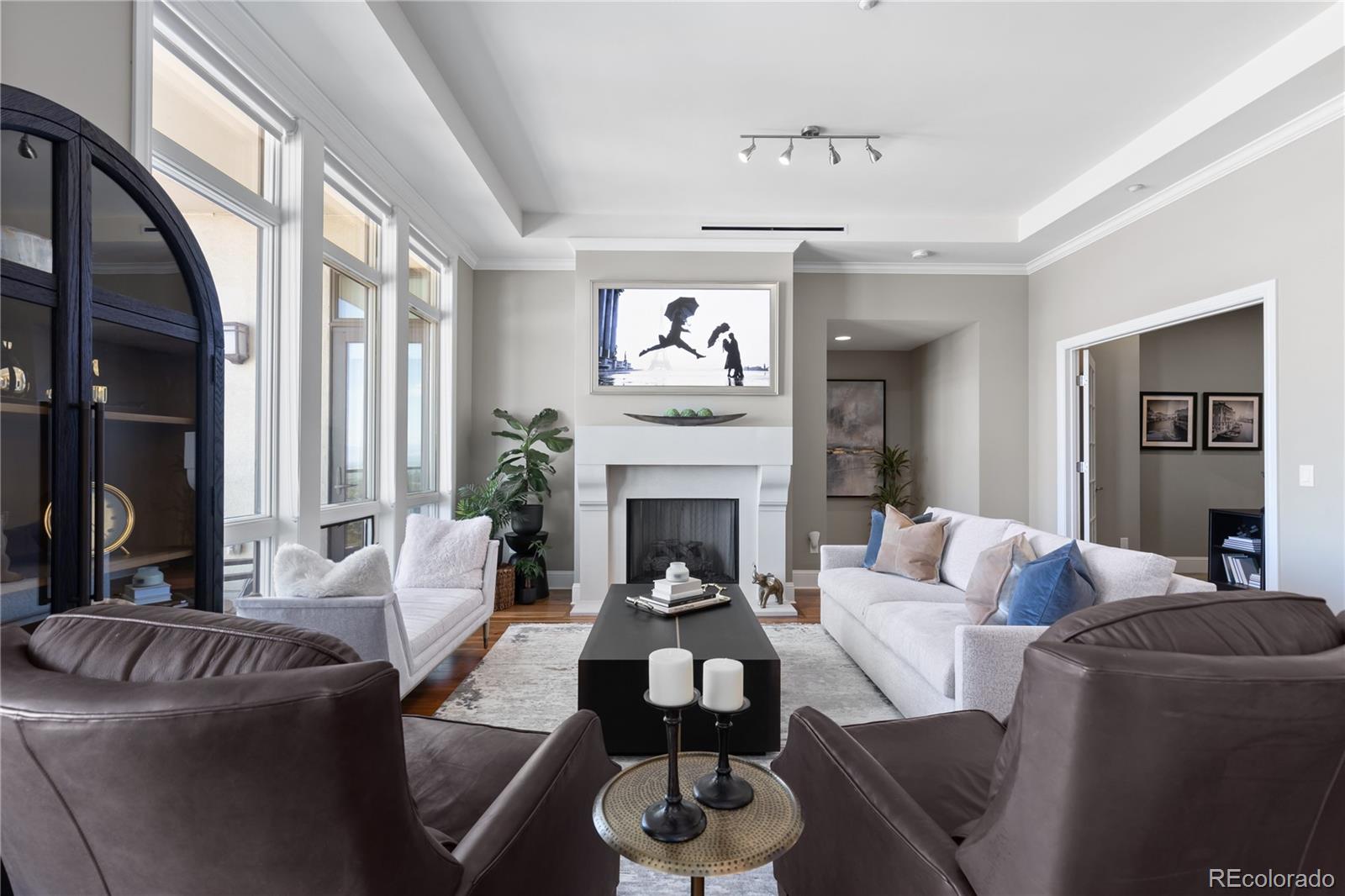 a living room with furniture a fireplace and a large mirror