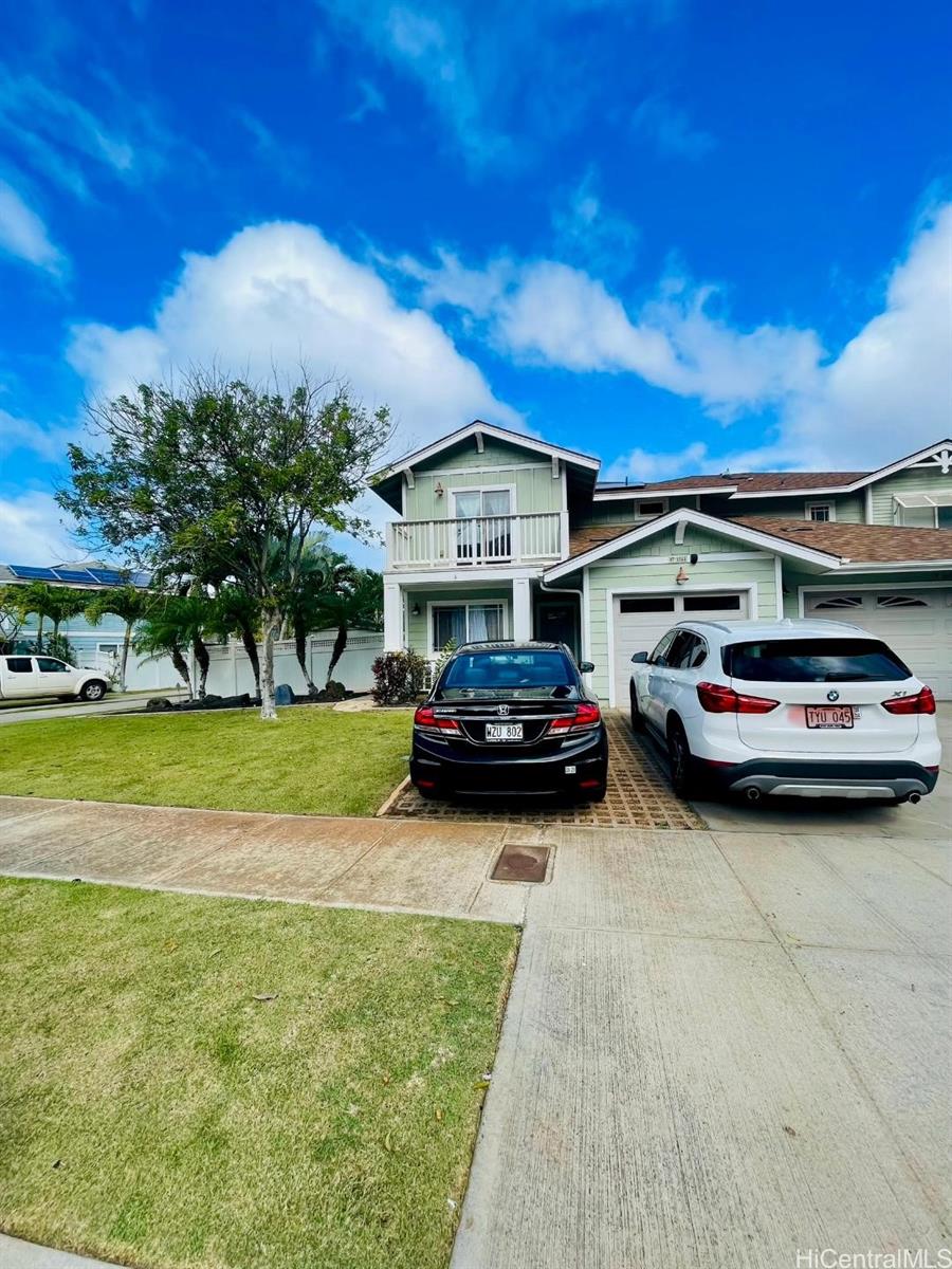 a car parked in front of a house with a yard