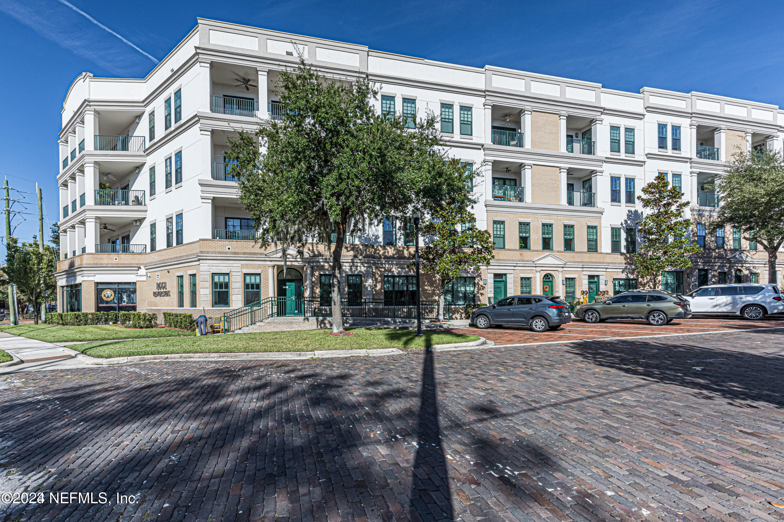 a front view of a residential apartment building with a yard