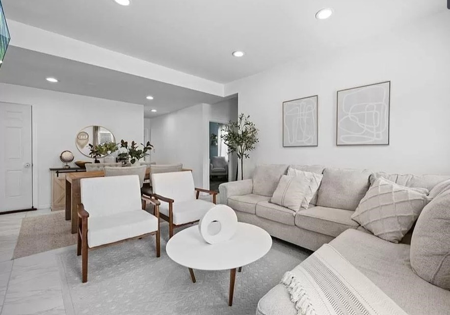 a living room with furniture and a potted plant