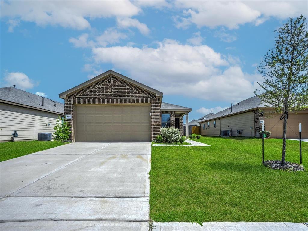 a front view of a house with a yard and garage