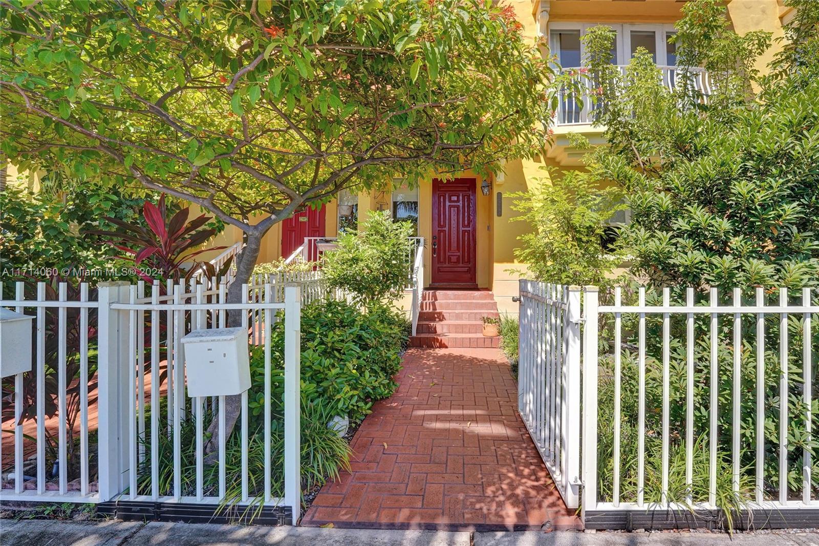 a view of a pathway of a house with a small yard