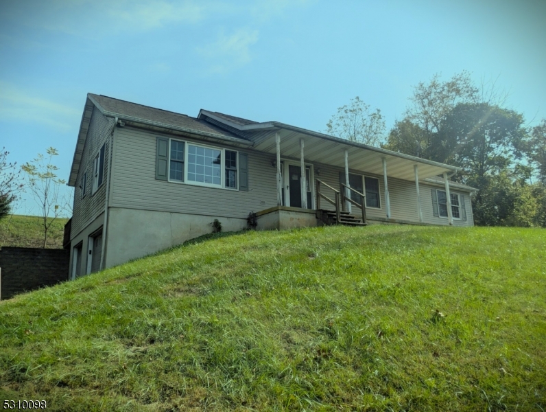 a house with green field in front of it