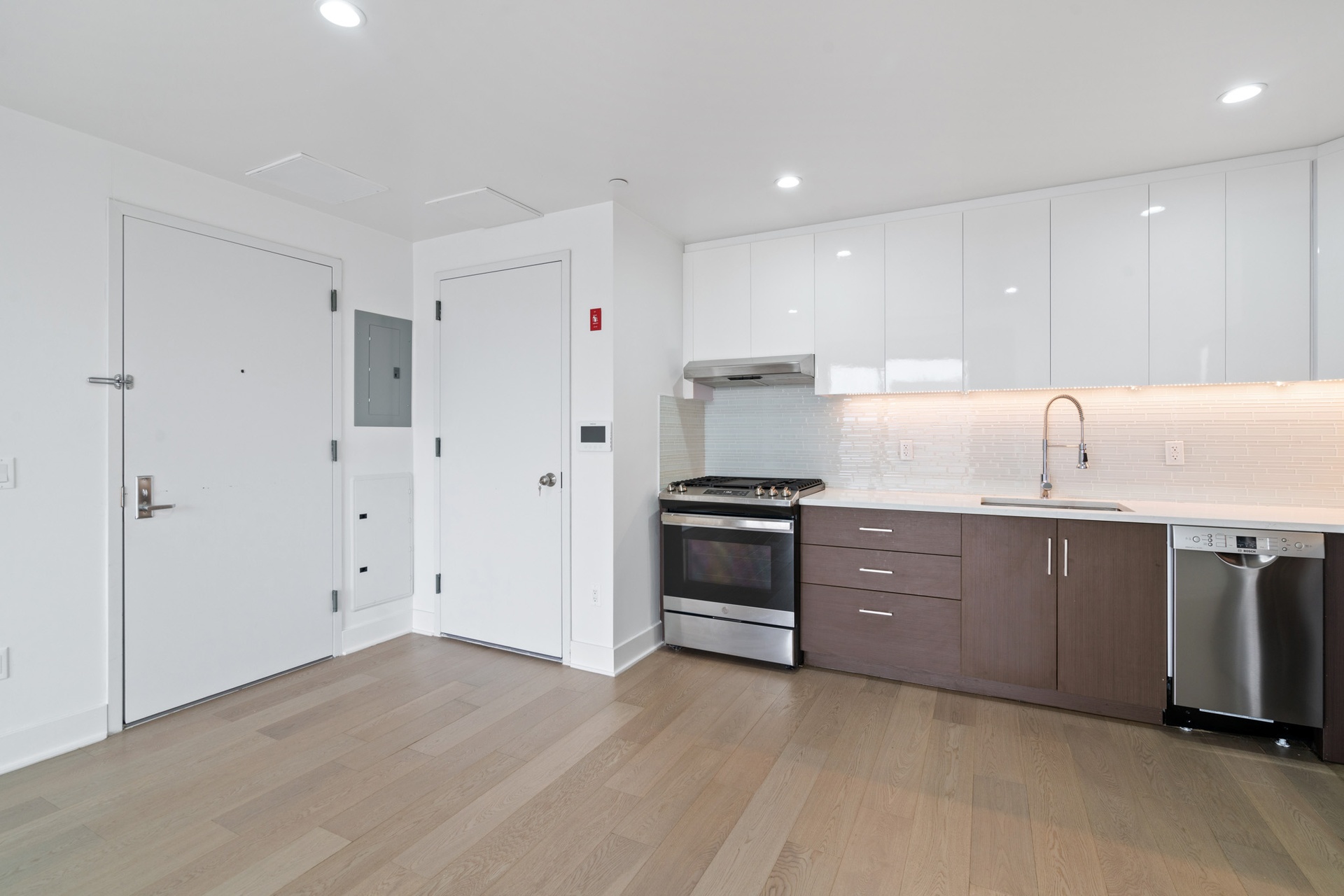 a kitchen with a sink and stainless steel appliances