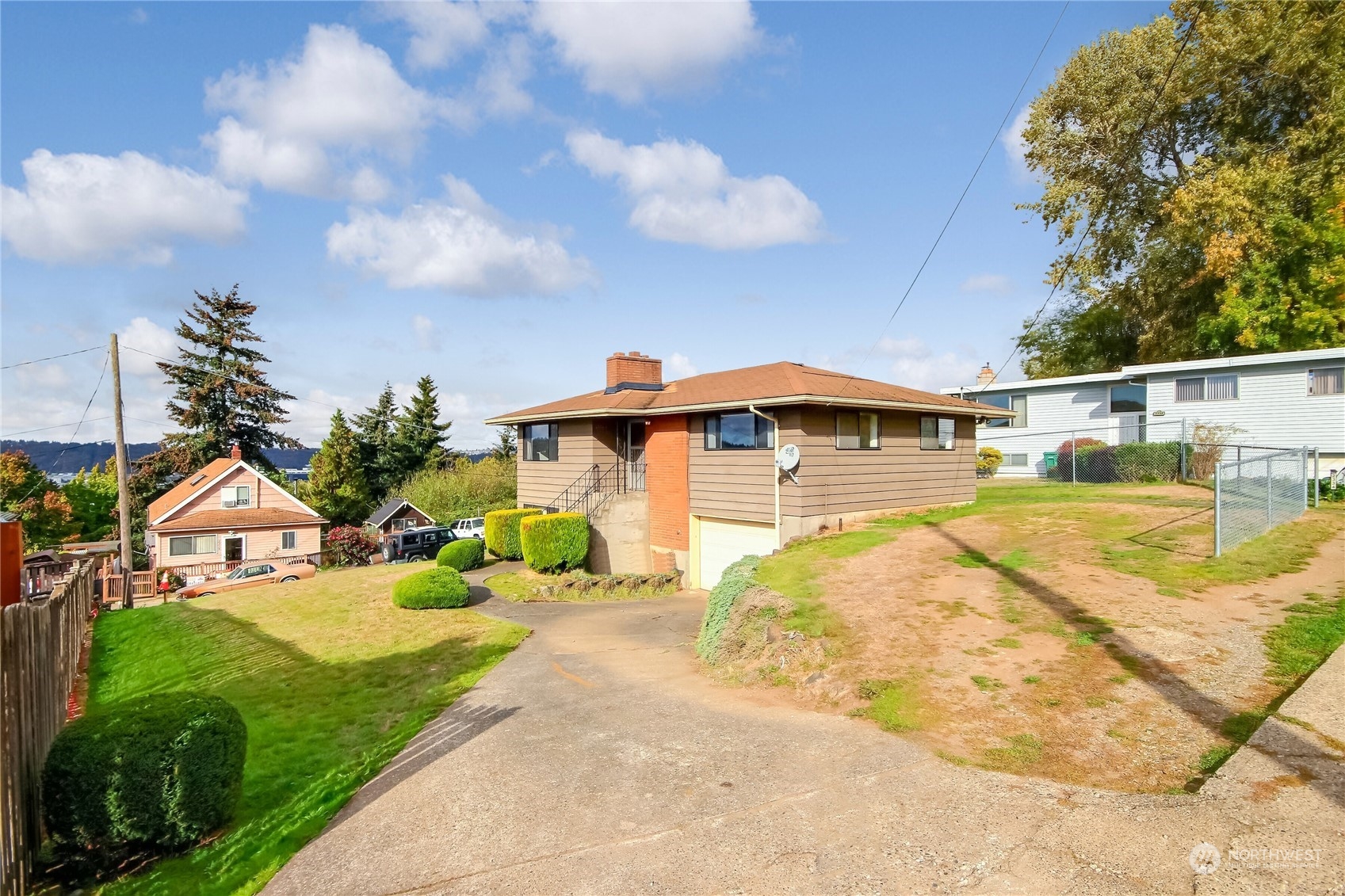 a view of residential houses with yard and entertaining space