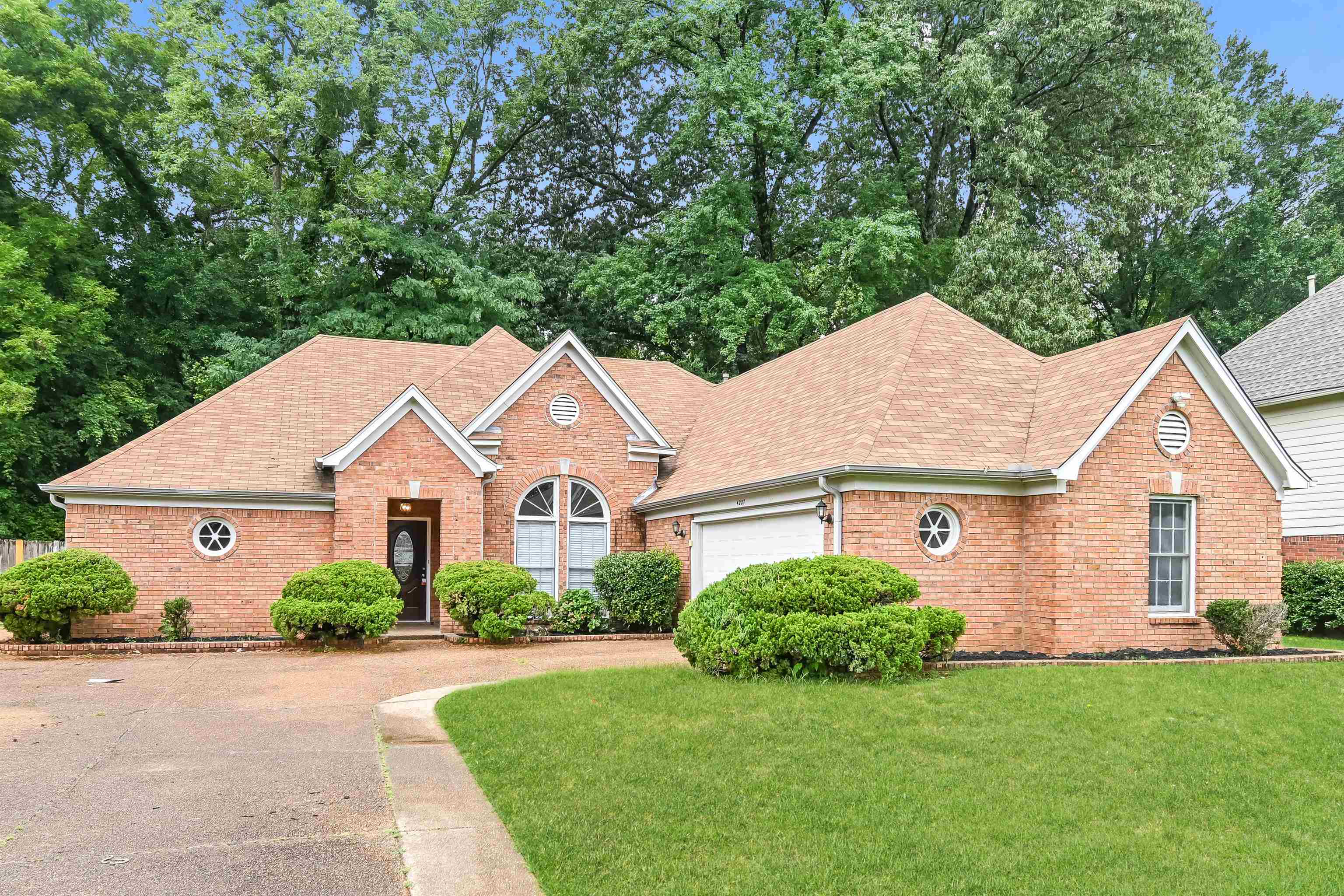 View of front of house with a garage and a front lawn