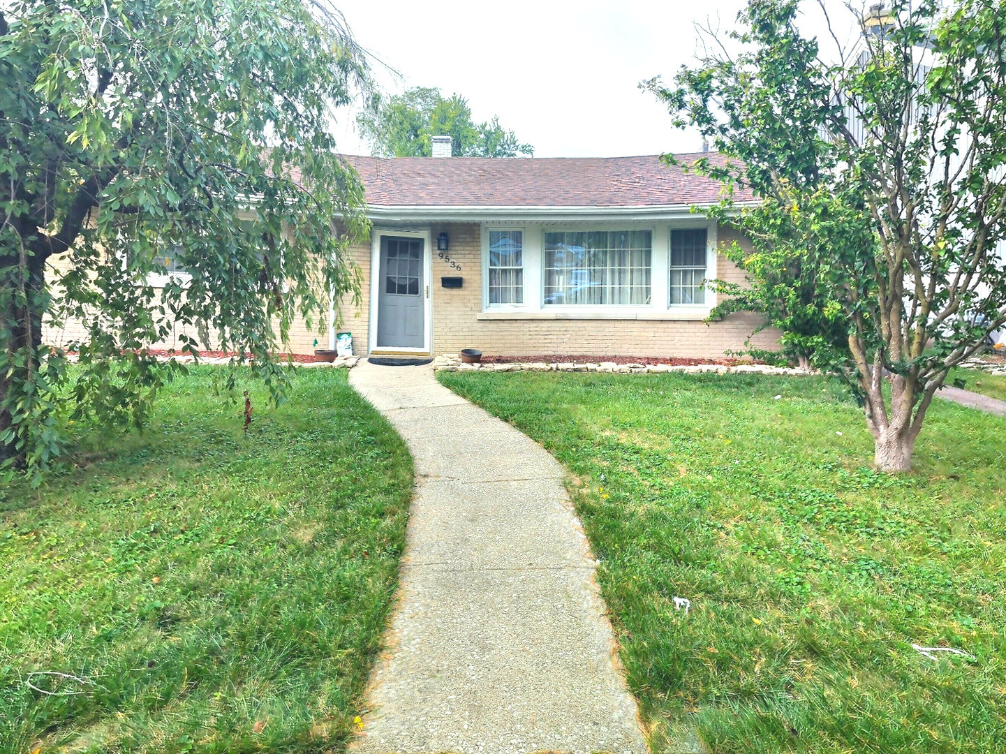 a front view of a house with yard