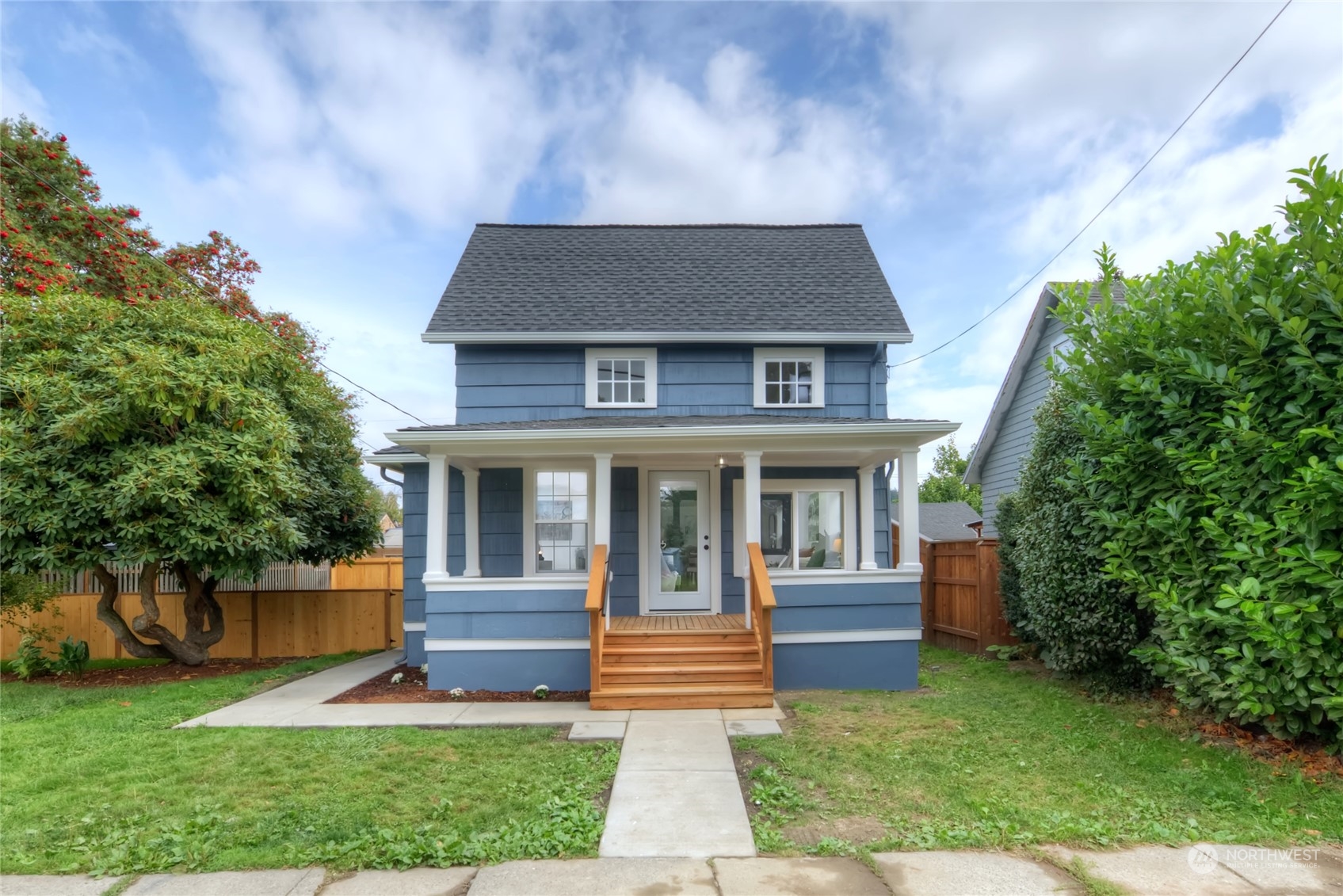 a front view of a house with a garden