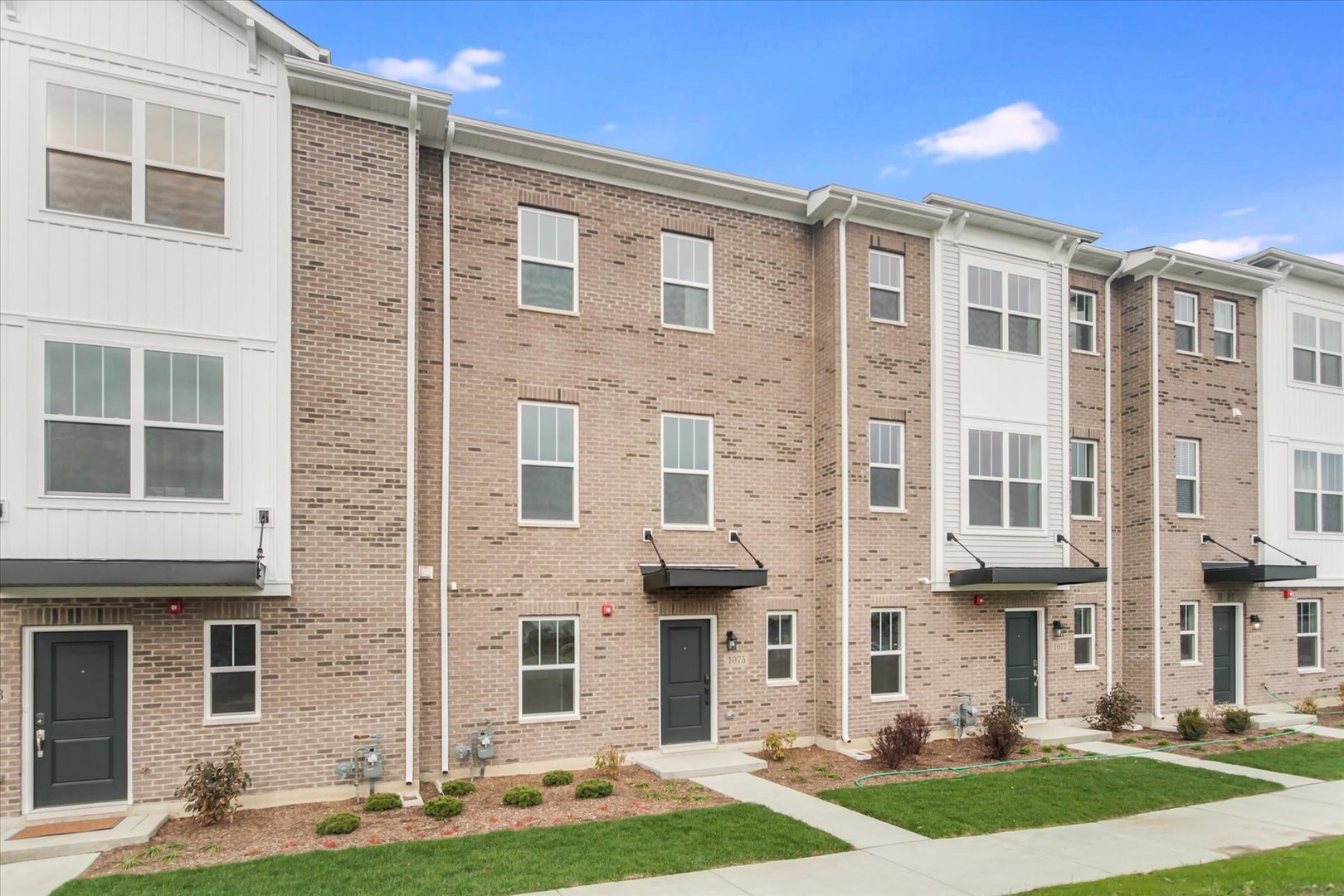 a front view of a building with a yard