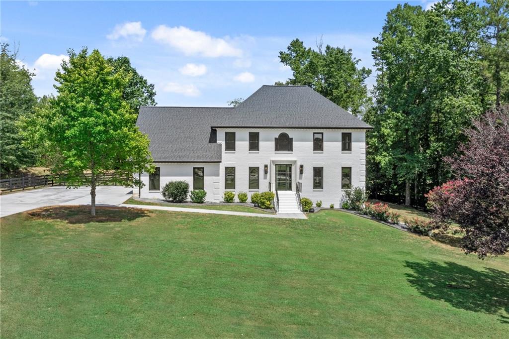 a front view of a house with a yard