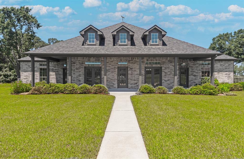 a front view of house with yard and green space