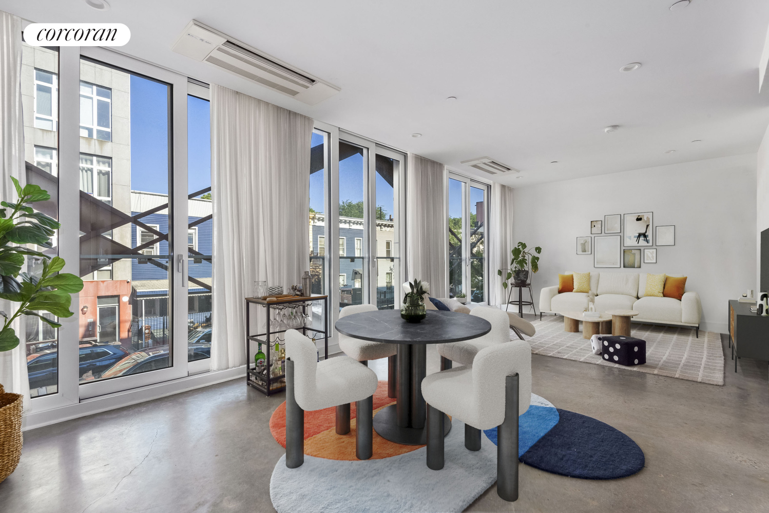 a living room with furniture and a floor to ceiling window