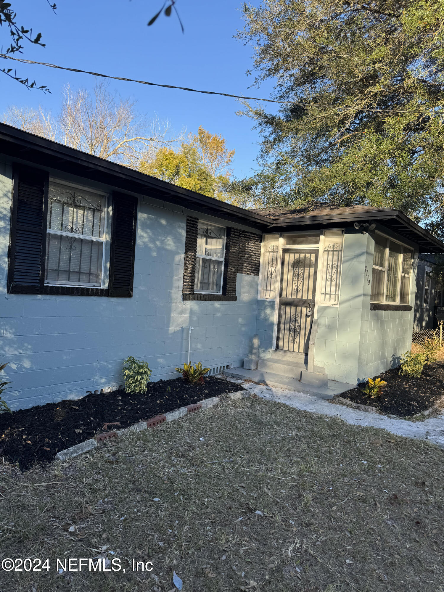 a backyard of a house with wooden fence and porch