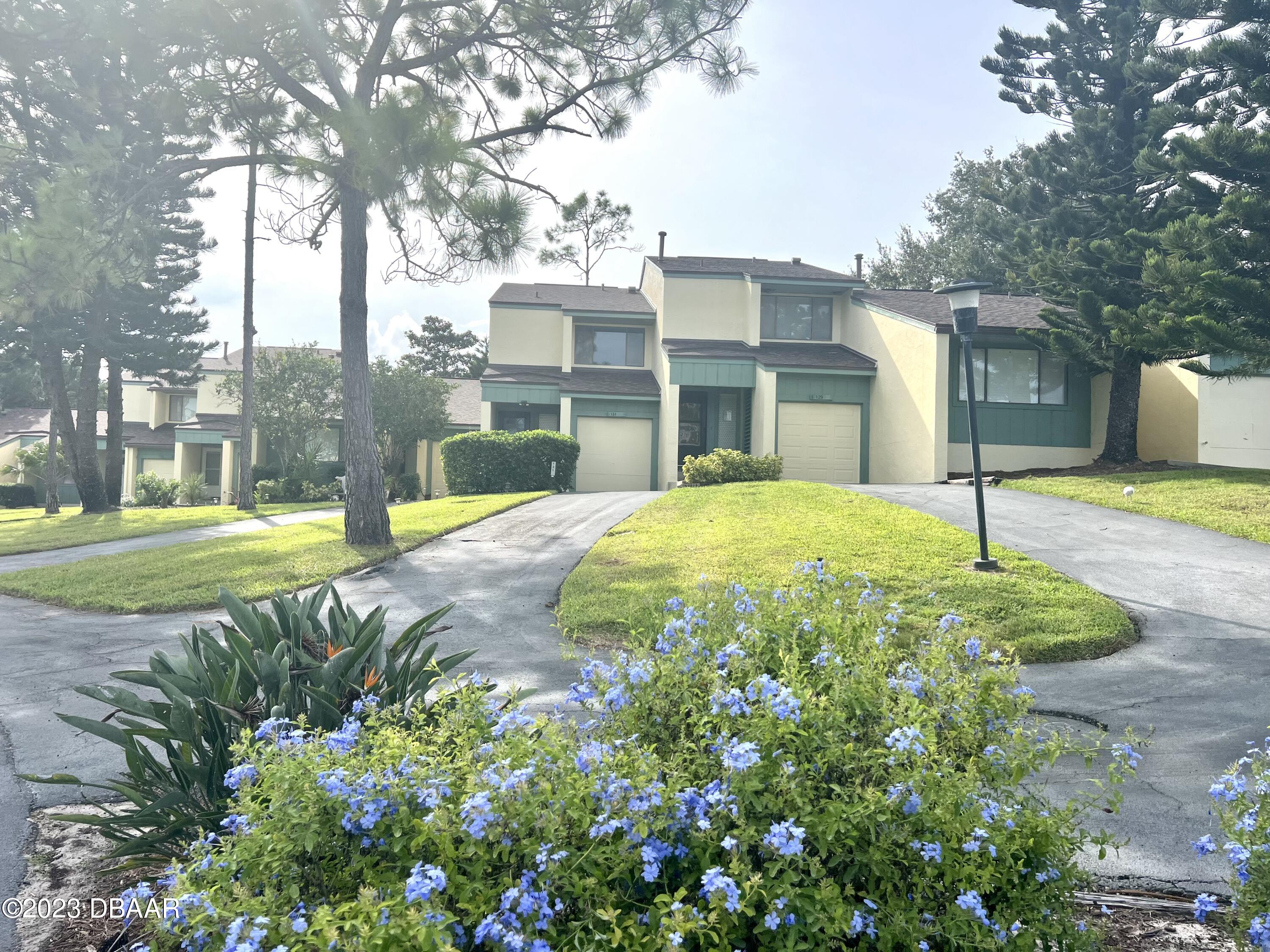 a view of a house with a yard