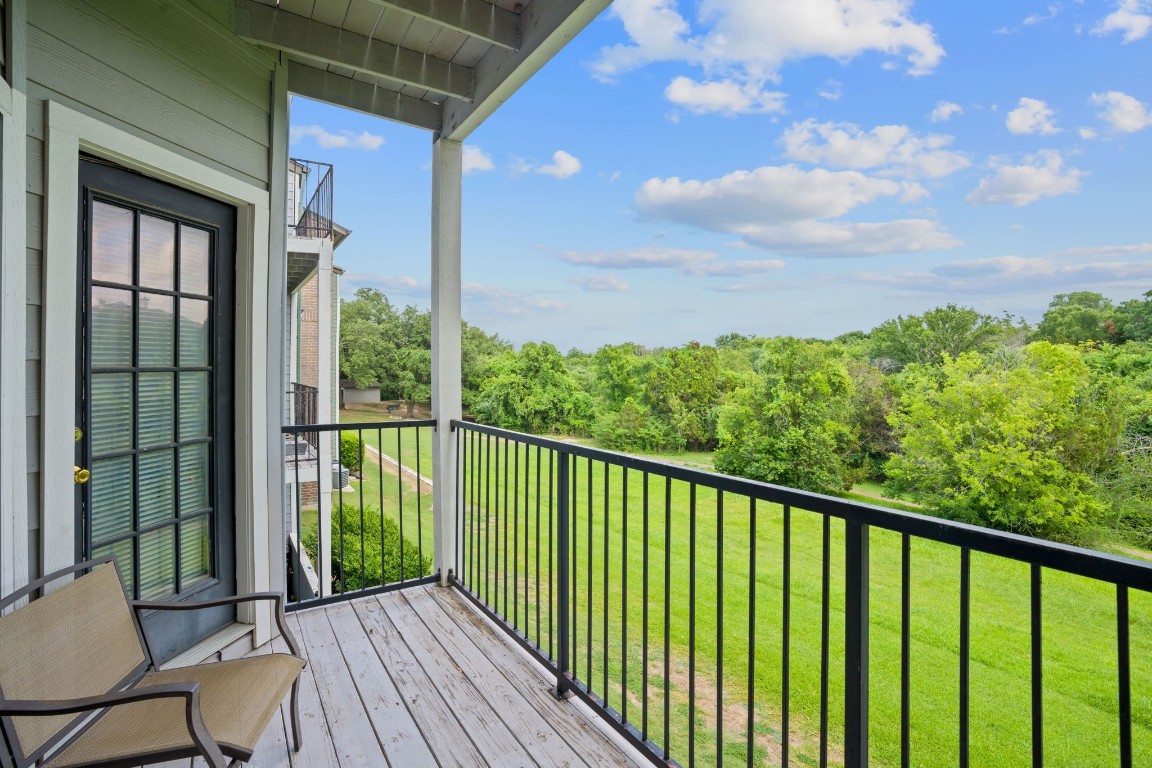 a view of a balcony with wooden floor