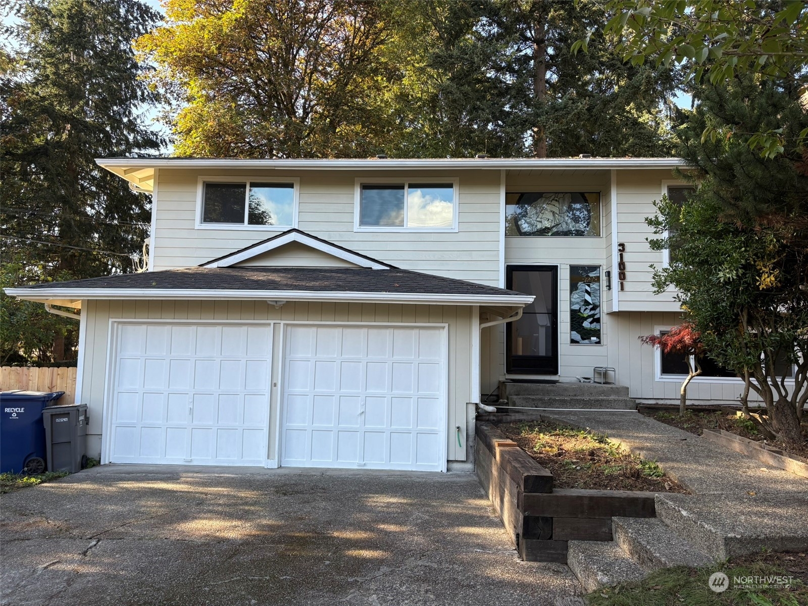 a view of a house with a yard and garage