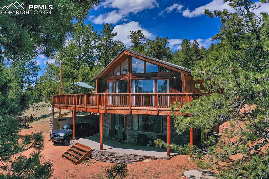 a view of a house with a yard balcony and tree