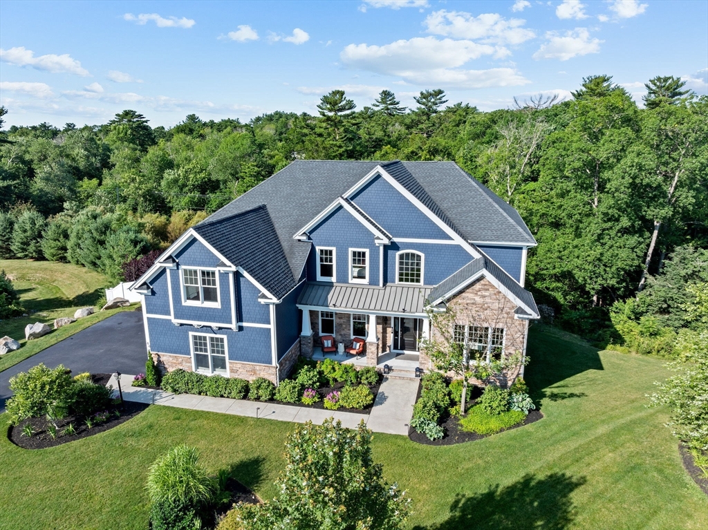 a aerial view of a house with yard and green space