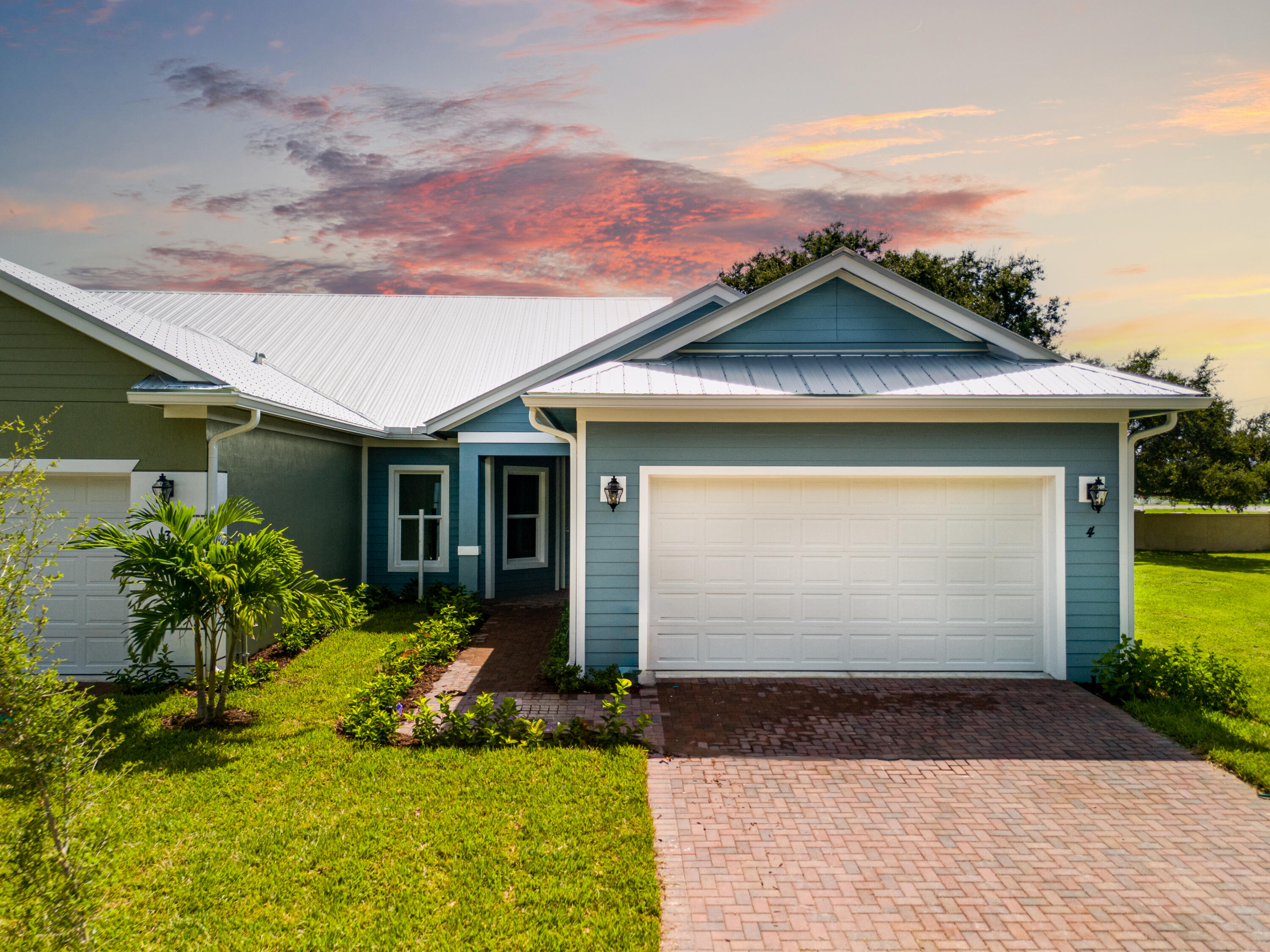 a front view of a house with a yard and outdoor seating