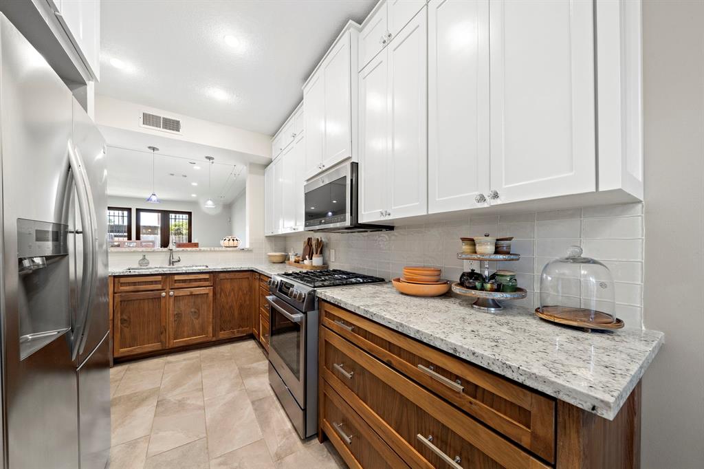 a kitchen with sink cabinets and stove top oven