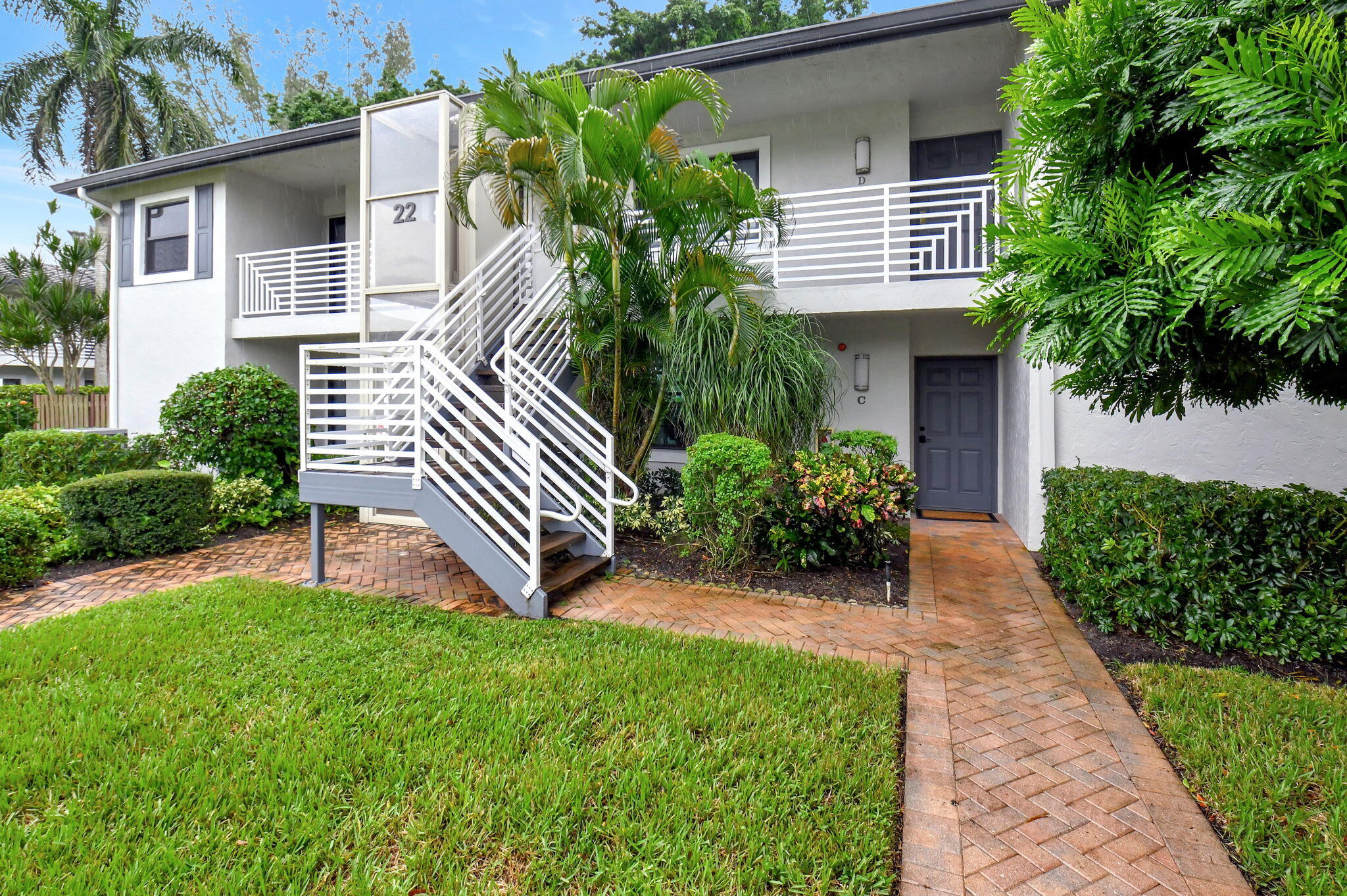 a front view of a house with a yard and outdoor seating