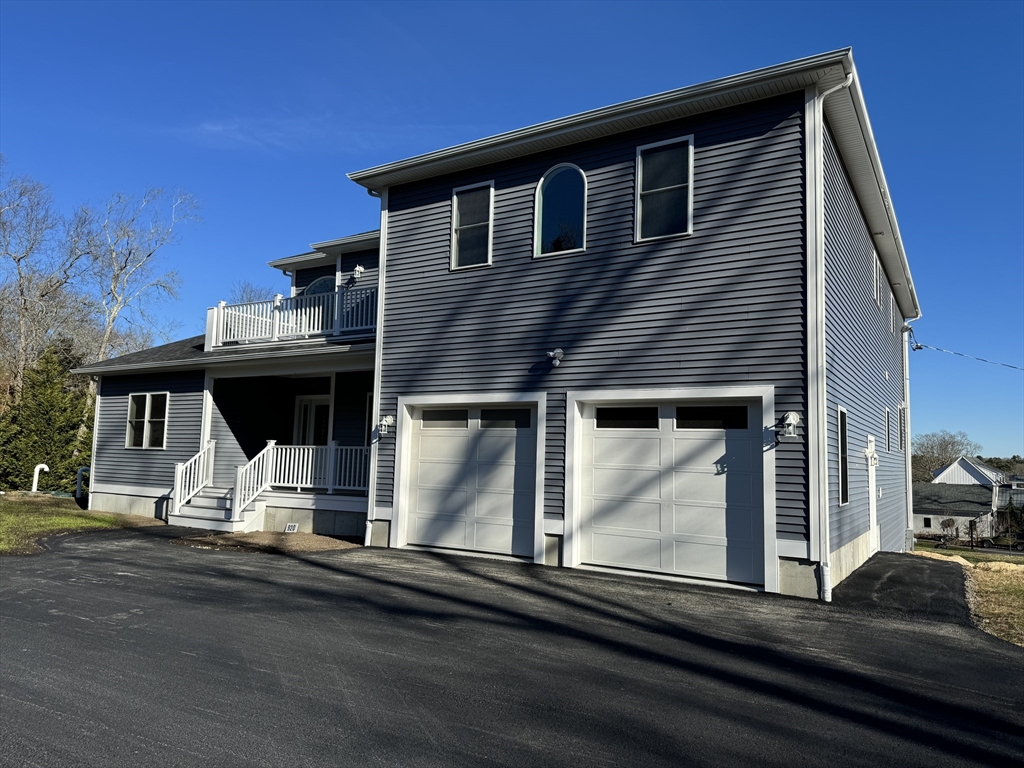 a front view of a house with a car parked