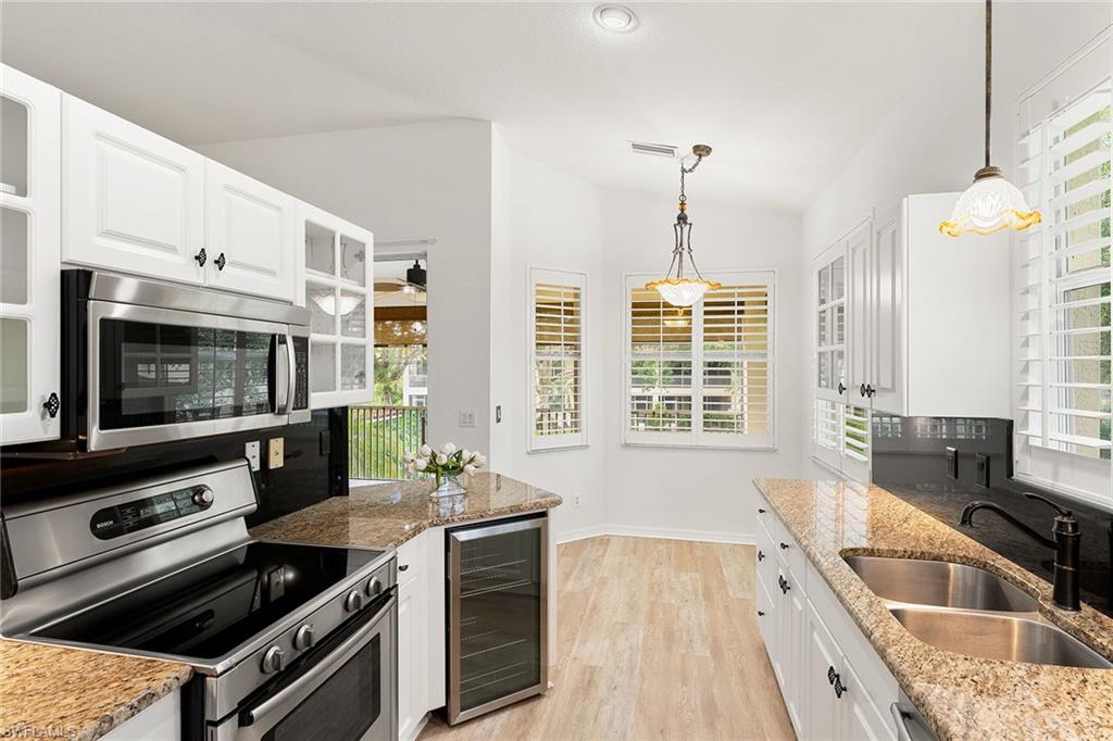 a kitchen with a stove a sink and a microwave